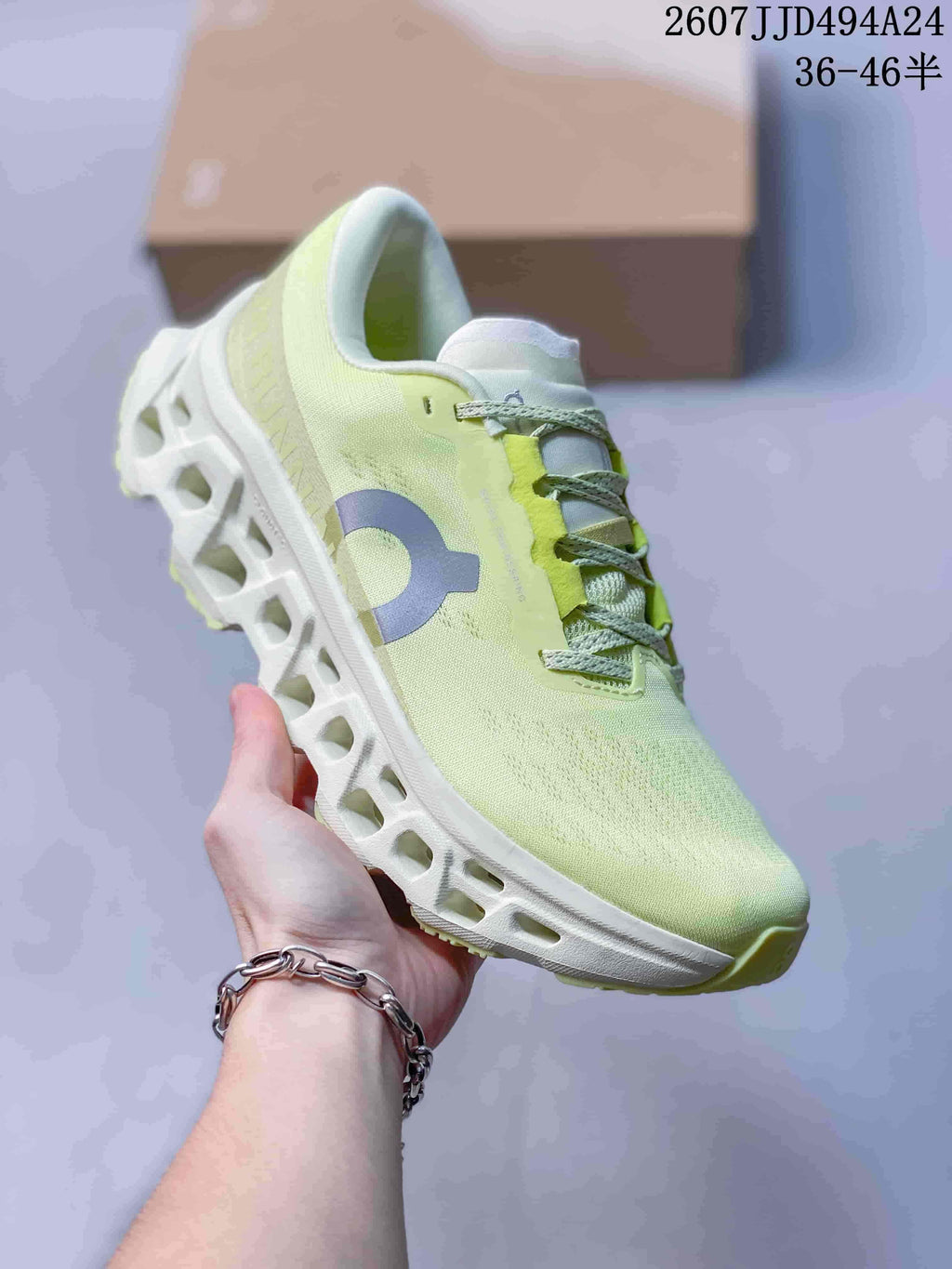 Angled side view of the pale lime green and white sneaker with visible On branding and sculpted outsole.