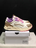 Side view of the Off-White-branded low-top sneakers with pink laces, purple lining, beige panels, and a cream midsole.