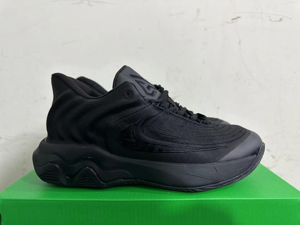 Side profile of one black sneaker showing layered panels and a sculpted sole.