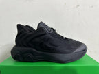 Side profile of one black sneaker showing layered panels and a sculpted sole.