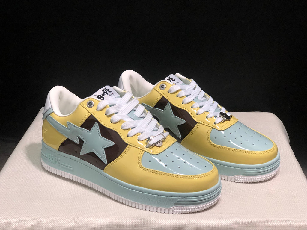 Front three-quarter view of the BAPE STA sneakers highlighting the perforated toe panels and star-shaped side details.