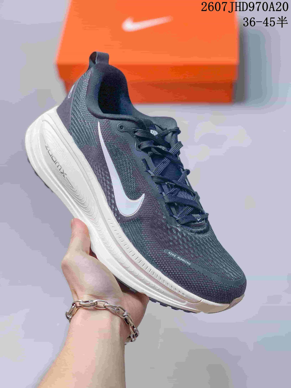 Black Nike Structure Plus running sneaker with a light Swoosh and white ZoomX-marked midsole.