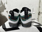 Rear view of black, white, and green Jordan basketball shoes with floral-patterned heel panels.