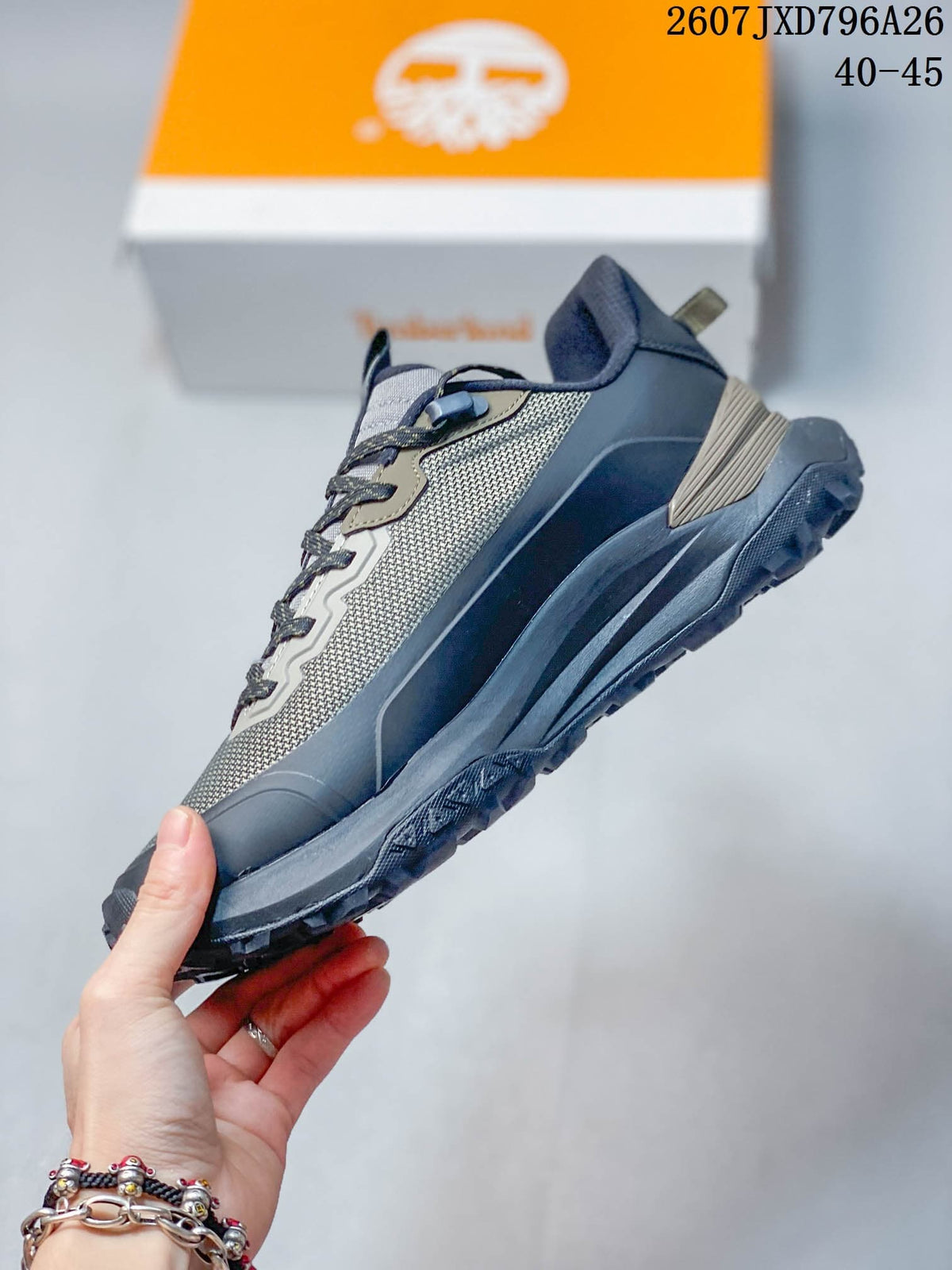 Side profile highlighting the gray mesh-look upper, layered overlays, midsole shape, and textured outsole.