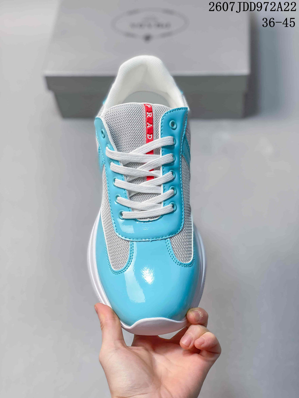 Top view showing the rounded toe, white laces, turquoise panels, and red tongue label.
