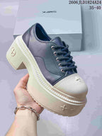 Angled view of a dark and ivory low-top sneaker with a chunky platform sole