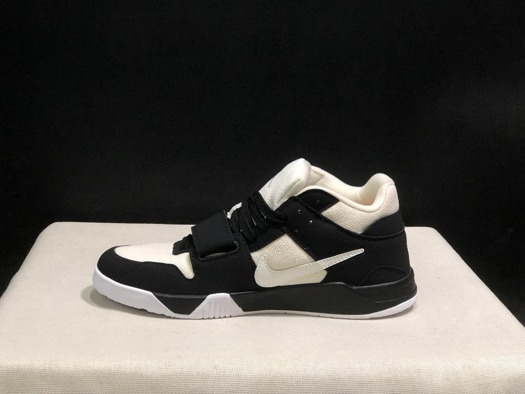 Side profile of one sneaker showing the layered black and white upper and white outsole.