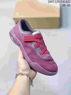 Angled view of a purple and red On Cloudnova sneaker showing the mesh-like upper, strap closure, and cushioned sole.
