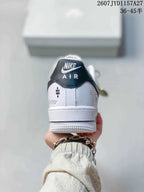 Rear view of a white and black sneaker showing the Nike Air tongue label, heel graphics, and textured white sole.