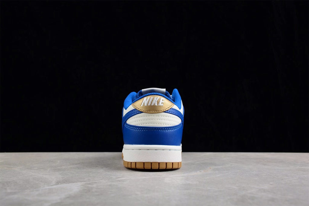 Rear view of the sneaker showing blue and white heel panels with a gold accent and Nike branding.