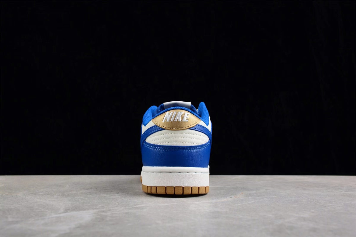 Rear view of the sneaker showing blue and white heel panels with a gold accent and Nike branding.