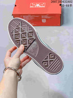 View of the patterned rubber outsole and red shoebox
