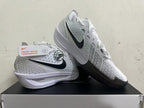 White Nike basketball shoes shown from the side, highlighting perforated panels and black accents.