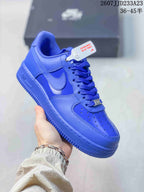 Angled side view of the blue Nike Air Force 1 sneaker showing the Swoosh, laces and rubber sole.
