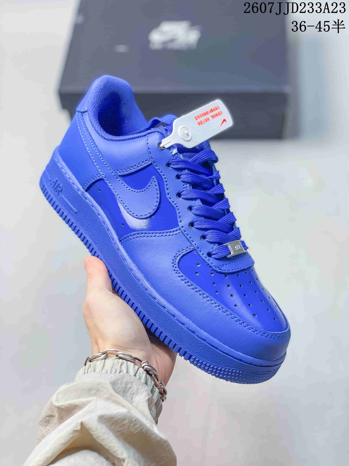 Angled side view of the blue Nike Air Force 1 sneaker showing the Swoosh, laces and rubber sole.