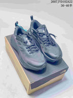 Pair of dark gray The North Face Altamesa 500 sneakers displayed on a shoe box.