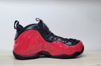 Side profile of a red and black Nike Foamposite Pro sneaker