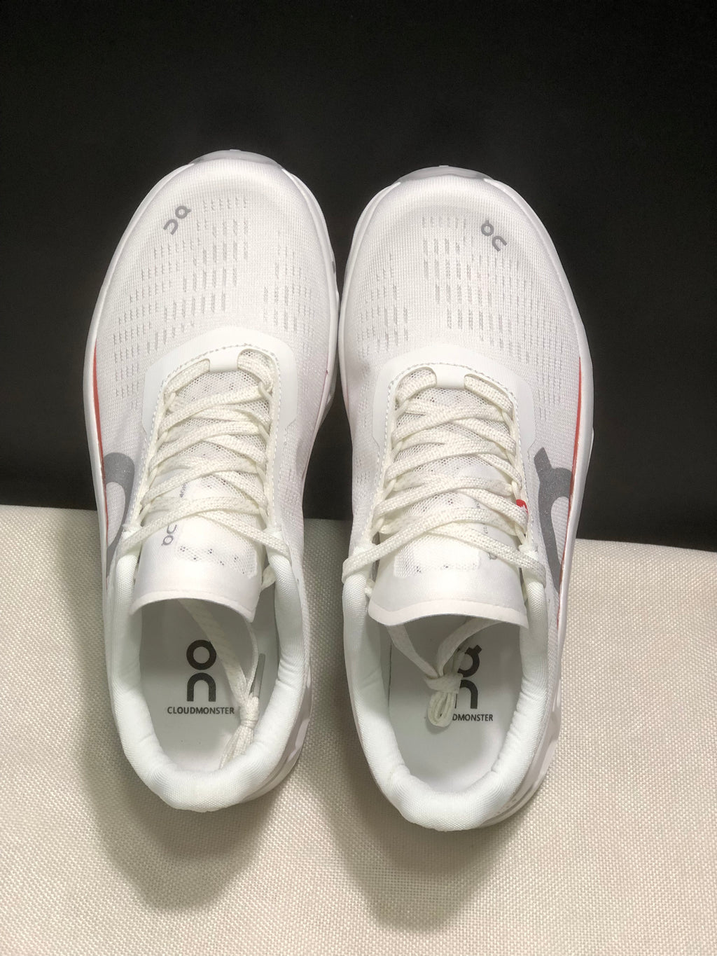 Top view of the pair showing white uppers, laces and Cloudmonster branding on the insoles.