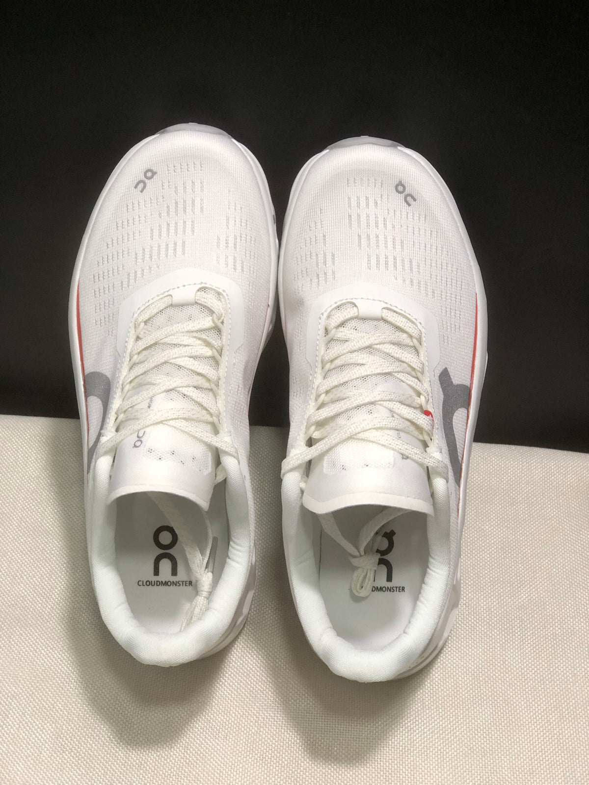 Top view of the pair showing white uppers, laces and Cloudmonster branding on the insoles.