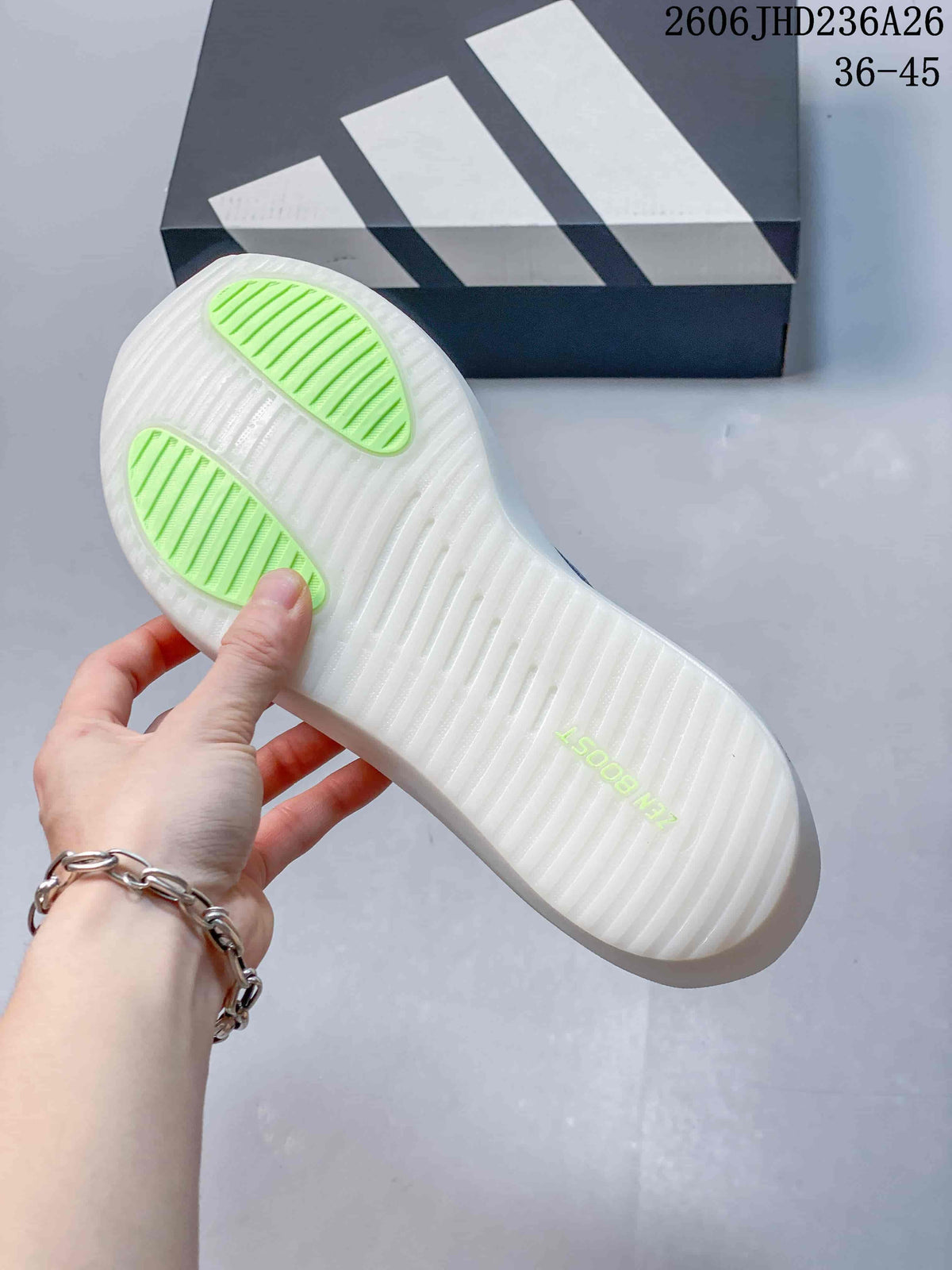 Underside of the shoe showing a white outsole and bright green traction areas.