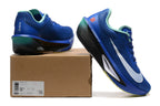 Blue Nike Zoom Fly 6 shoes with mint and yellow details beside a box showing a sample size label