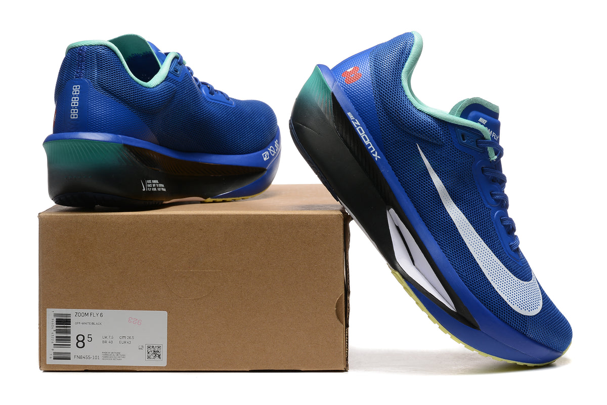 Blue Nike Zoom Fly 6 shoes with mint and yellow details beside a box showing a sample size label
