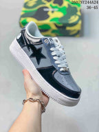 Black, gray and white low-top sneaker with glossy star side graphic and white sole; source overlay shows style code 2607NY244A24 and size range 36–45.