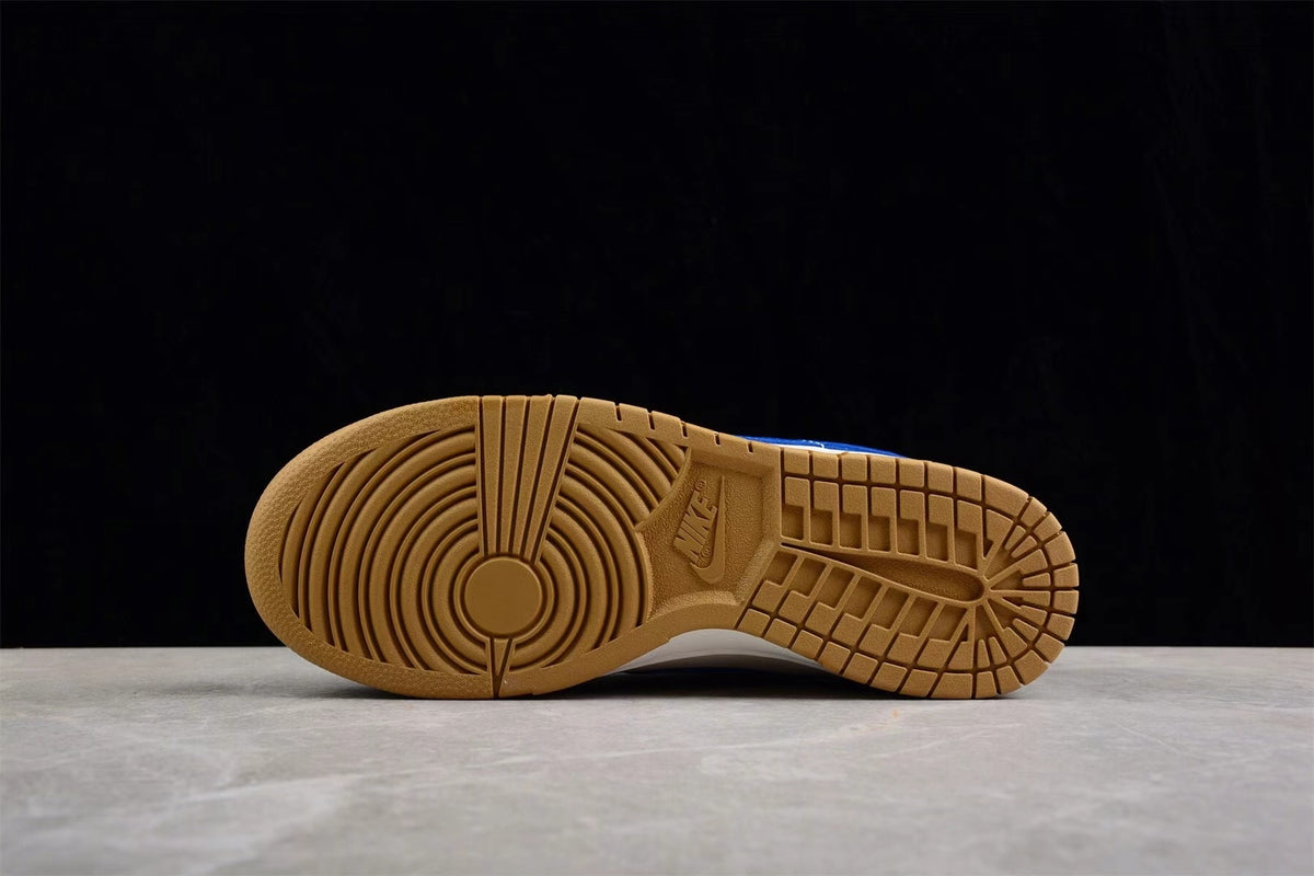 Gum-colored outsole viewed from below, showing circular forefoot grooves and patterned traction sections.