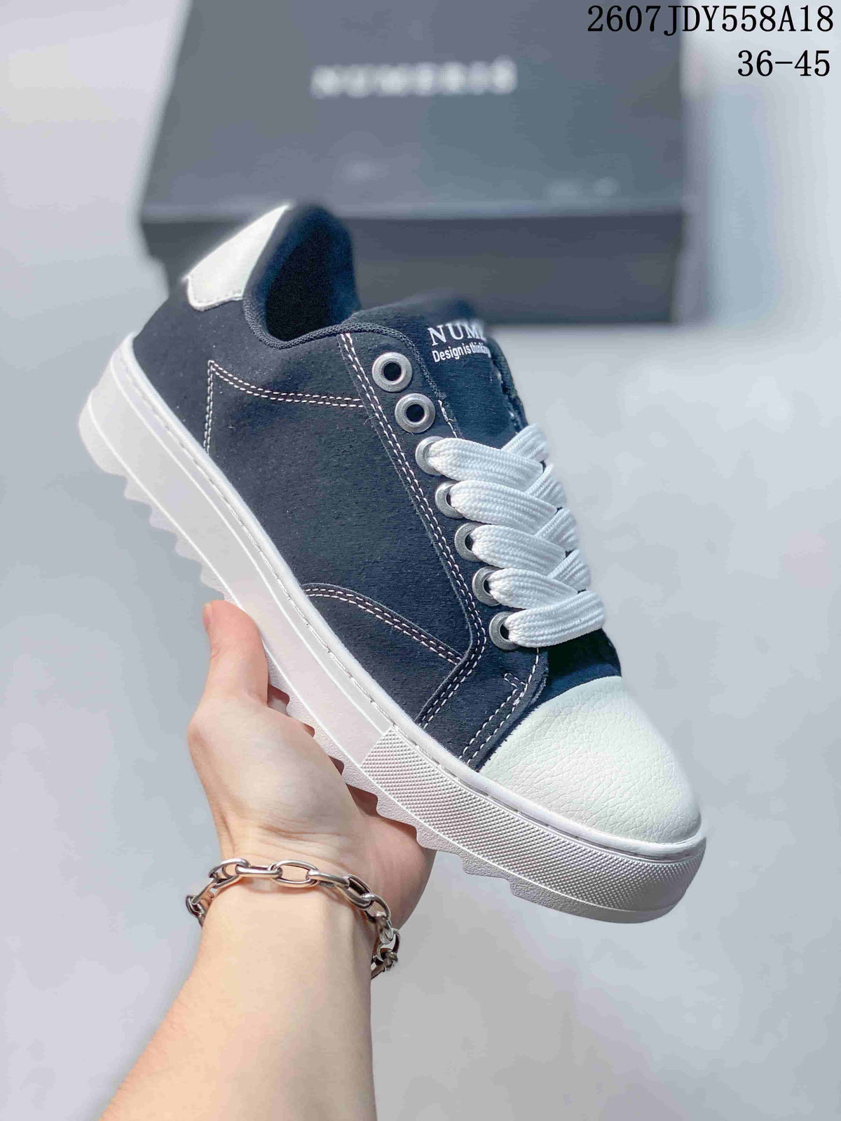 Dark navy NUMERIS low-top sneaker with white laces, white toe cap and contrasting white stitching; image shows size range 36-45.
