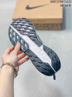 Underside view showing the dark lugged outsole and contrasting white midsole.