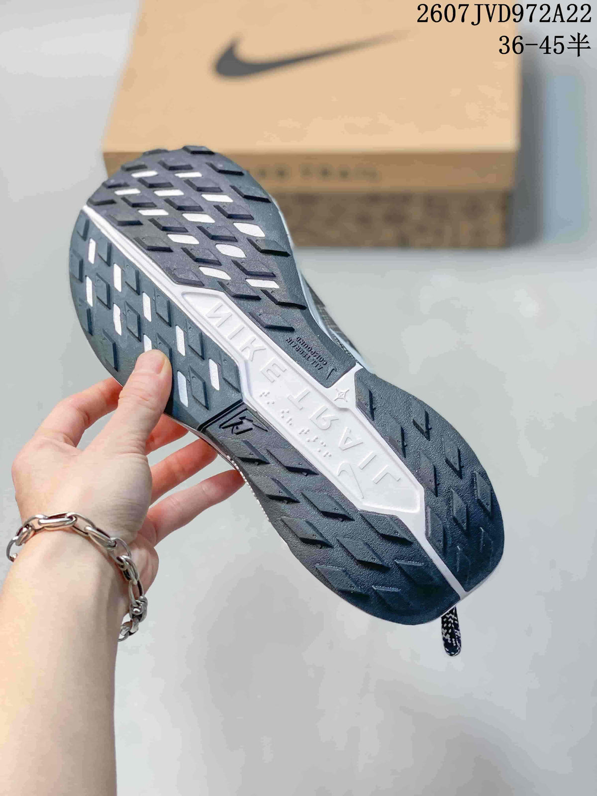 Underside view showing the dark lugged outsole and contrasting white midsole.