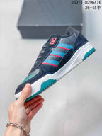 Side profile showing the navy upper, teal and red side stripes, white midsole, and teal outsole.
