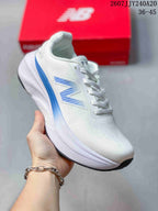 Angled side view of the white and blue New Balance sneaker with a raised midsole.