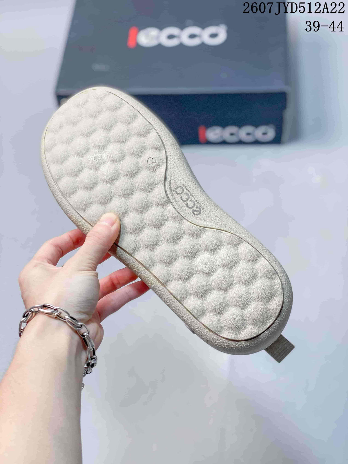 Close-up of the textured light-colored outsole and cushioned insole area of a beige ECCO sneaker.