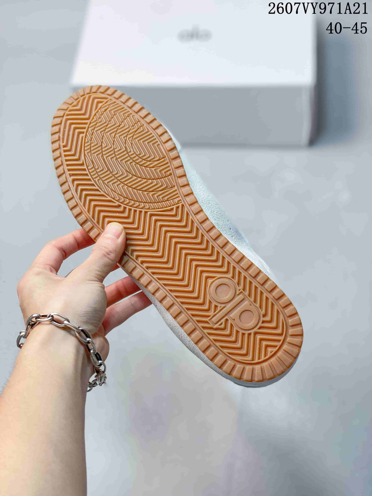 Close-up of the gum-colored outsole showing its textured zigzag tread and embossed branding.