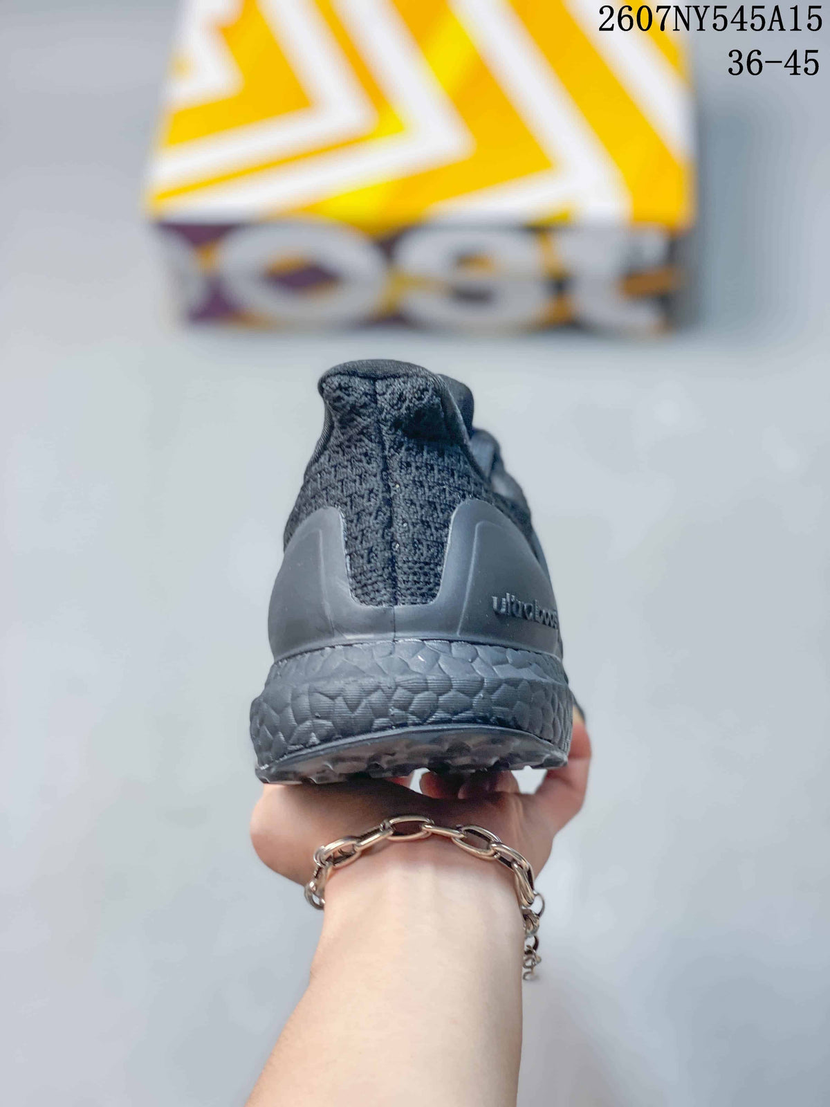 Rear view of the dark gray sneaker showing the padded heel collar, heel counter, textured midsole, and outsole edge.
