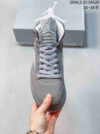 Front view of a grey Jordan high-top sneaker with light-colored laces
