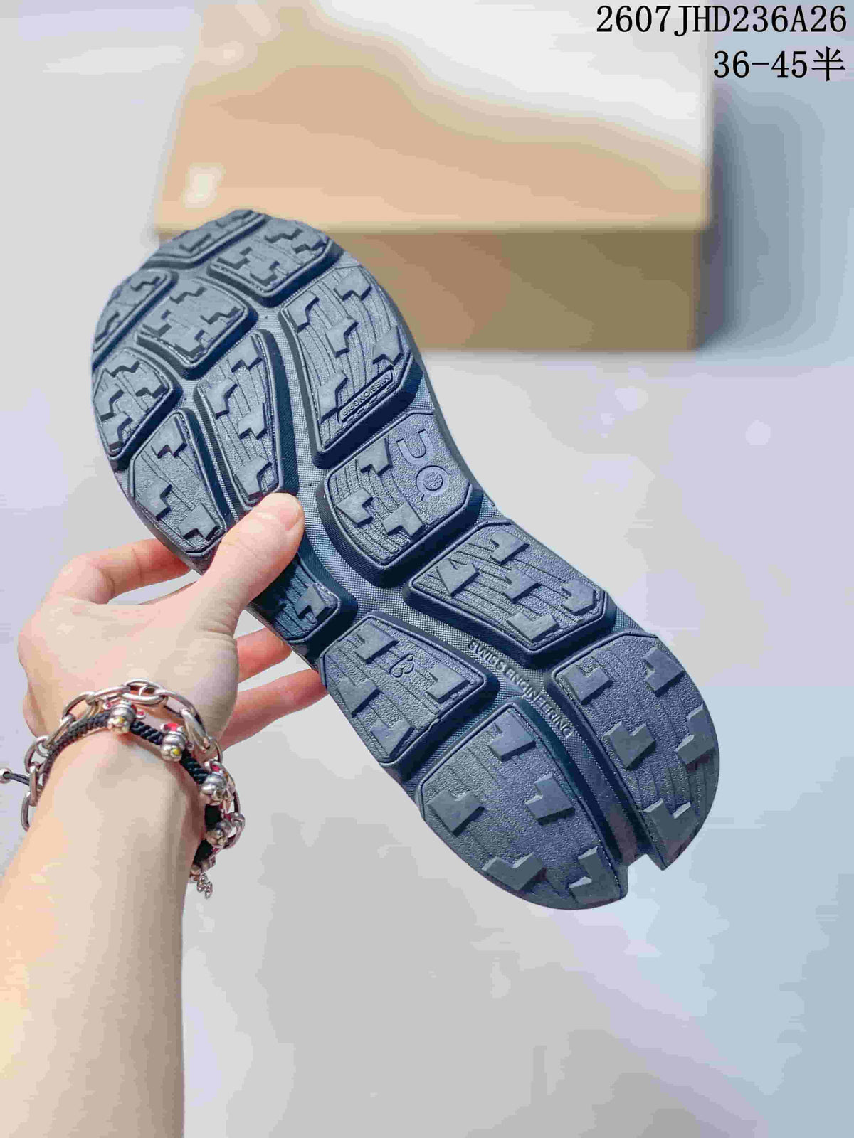Close view of the dark gray shoe outsole showing segmented tread blocks and deep grooves; overlay text shows 2607JHD236A26 and 36–45.5.