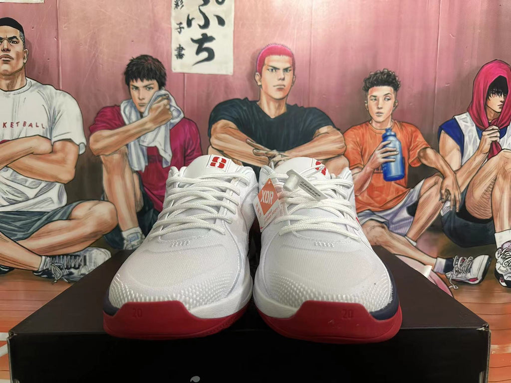 Front view of white Nike basketball shoes with red outsole details; a size 40 marking is visible.