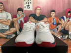 Front view of white Nike basketball shoes with red outsole details; a size 40 marking is visible.