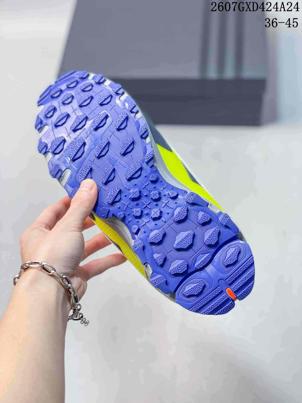 Close view of the sneaker outsole showing a blue textured tread with neon yellow side detailing.