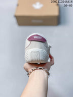 Rear view of the white sneaker showing the heel branding and molded outsole details; the image shows the code 2607JXD248A18 and size range 36–40.