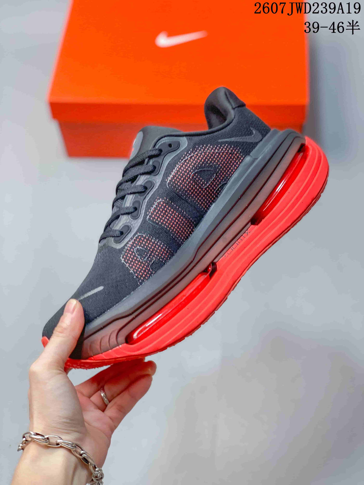 Side profile highlighting the layered dark upper, side overlays, and long red sole unit.