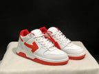 Three-quarter front view of the paired white and red low-top sneakers.
