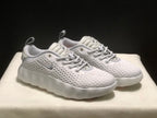 Three-quarter view of the white pair highlighting the textured upper, lace system and thick sculpted sole.