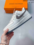 Side view of the cream sneaker with a patterned gray Swoosh and dark outsole.