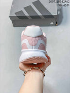 Rear view of the pink running shoe with a white midsole and heel details.