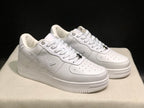 Angled side view of the white sneakers with tonal star panels and branded sidewalls.