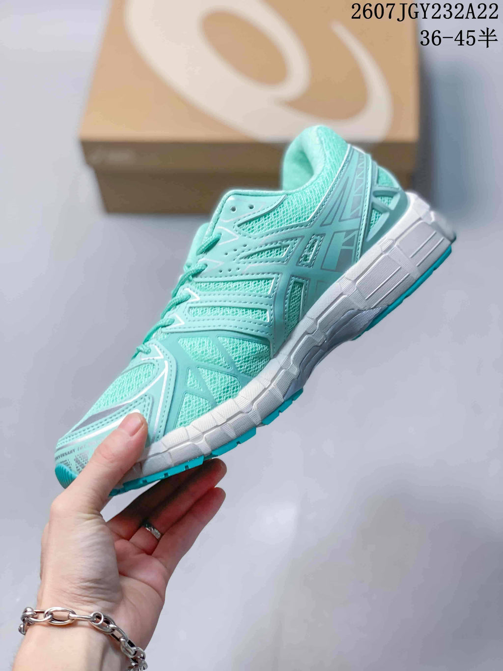 Side profile showing the mint mesh upper, structured overlays, and segmented white midsole.