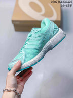 Side profile showing the mint mesh upper, structured overlays, and segmented white midsole.